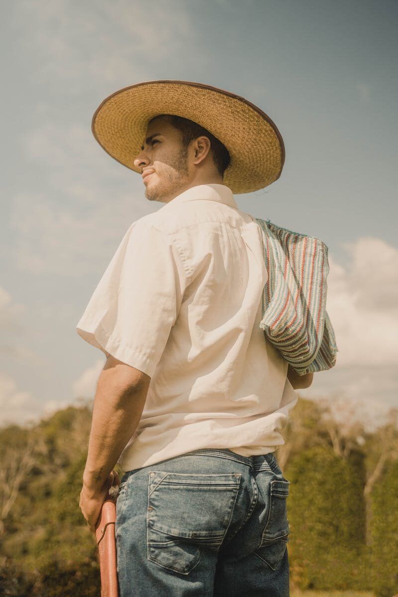Portrait of a farmer wearing a straw hat, standing in the countryside of Naranjos, San Martín, Peru.