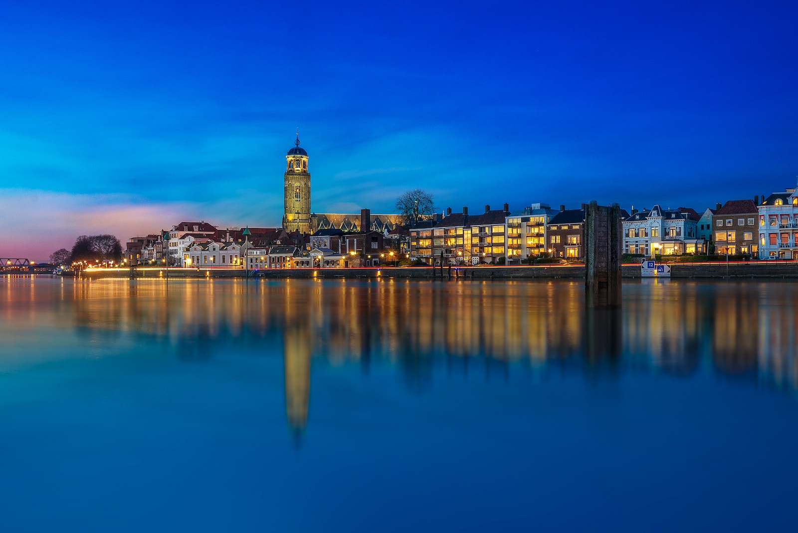 a large body of water with buildings in the background