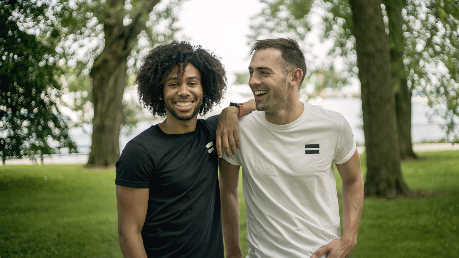 Two Men Standing on Grass Field